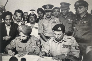 Lt. General A A K Niazi signing surrender document with Lt. General Jagjit Singh Aurora GOC-in-C of all Indian forces in the eastern theatre. 